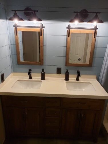 A bathroom with two sinks and two mirrors.