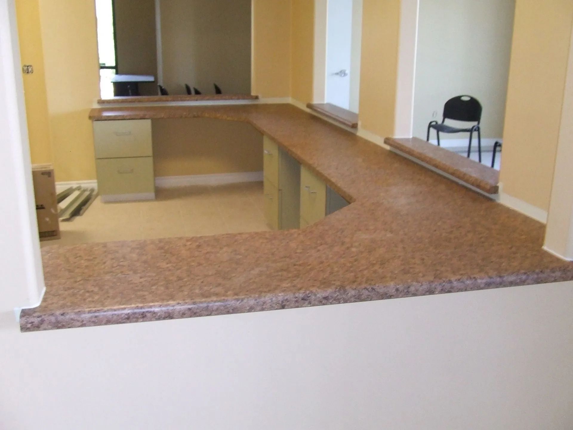 A room with a desk and a chair in it.