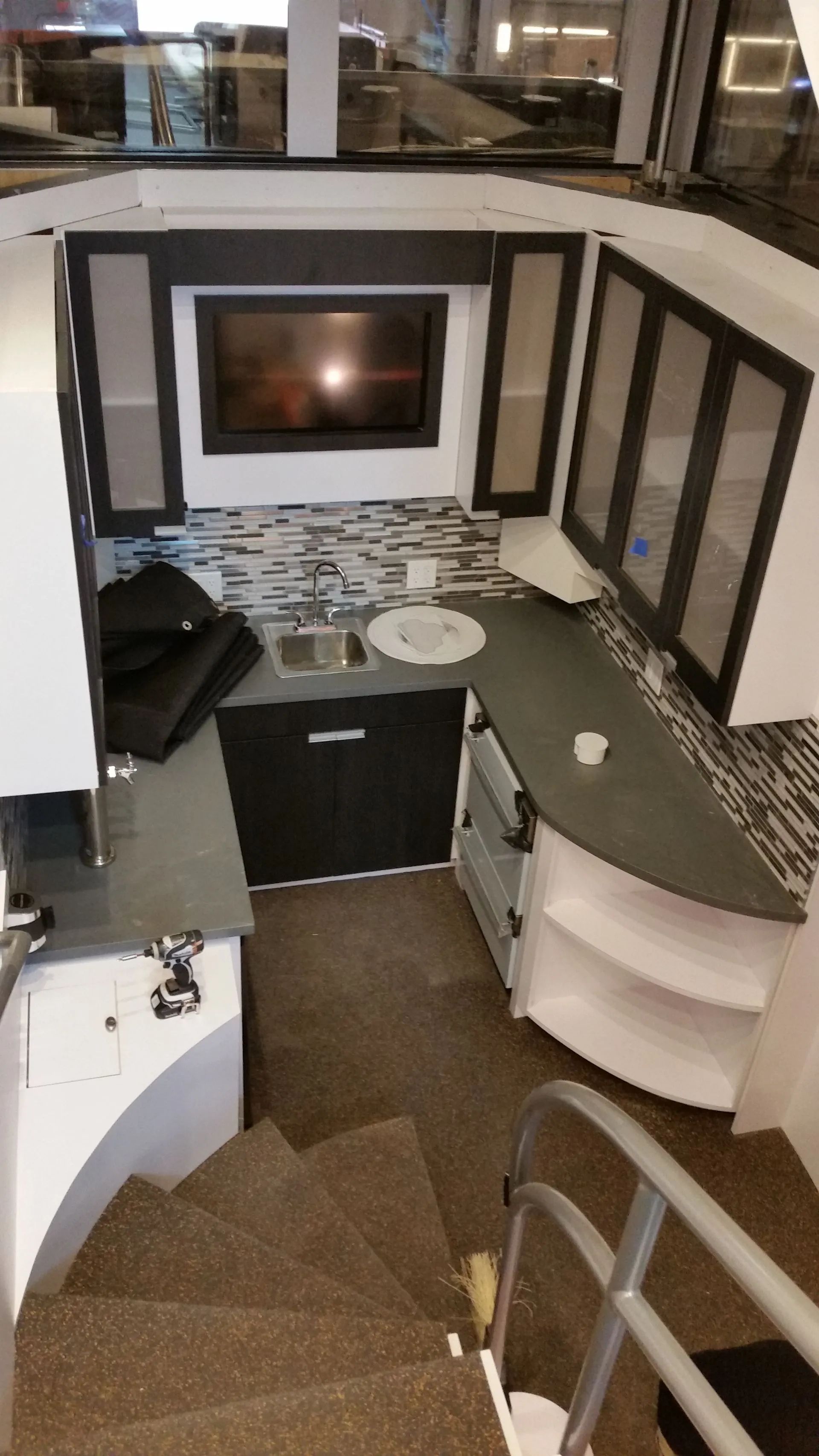 An aerial view of a kitchen with stairs leading up to it.