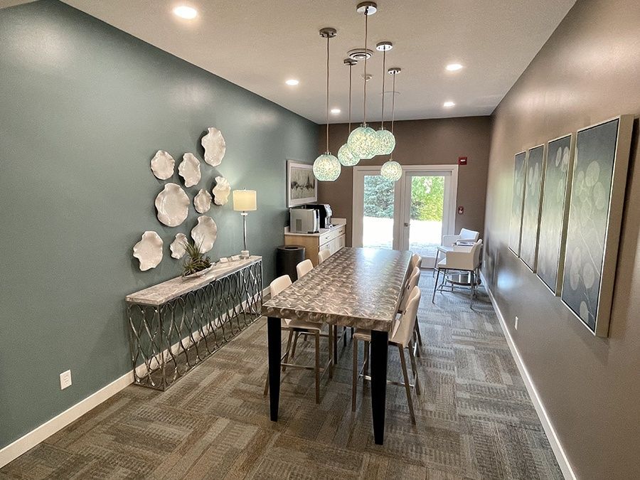 A room with a long table and chairs in it