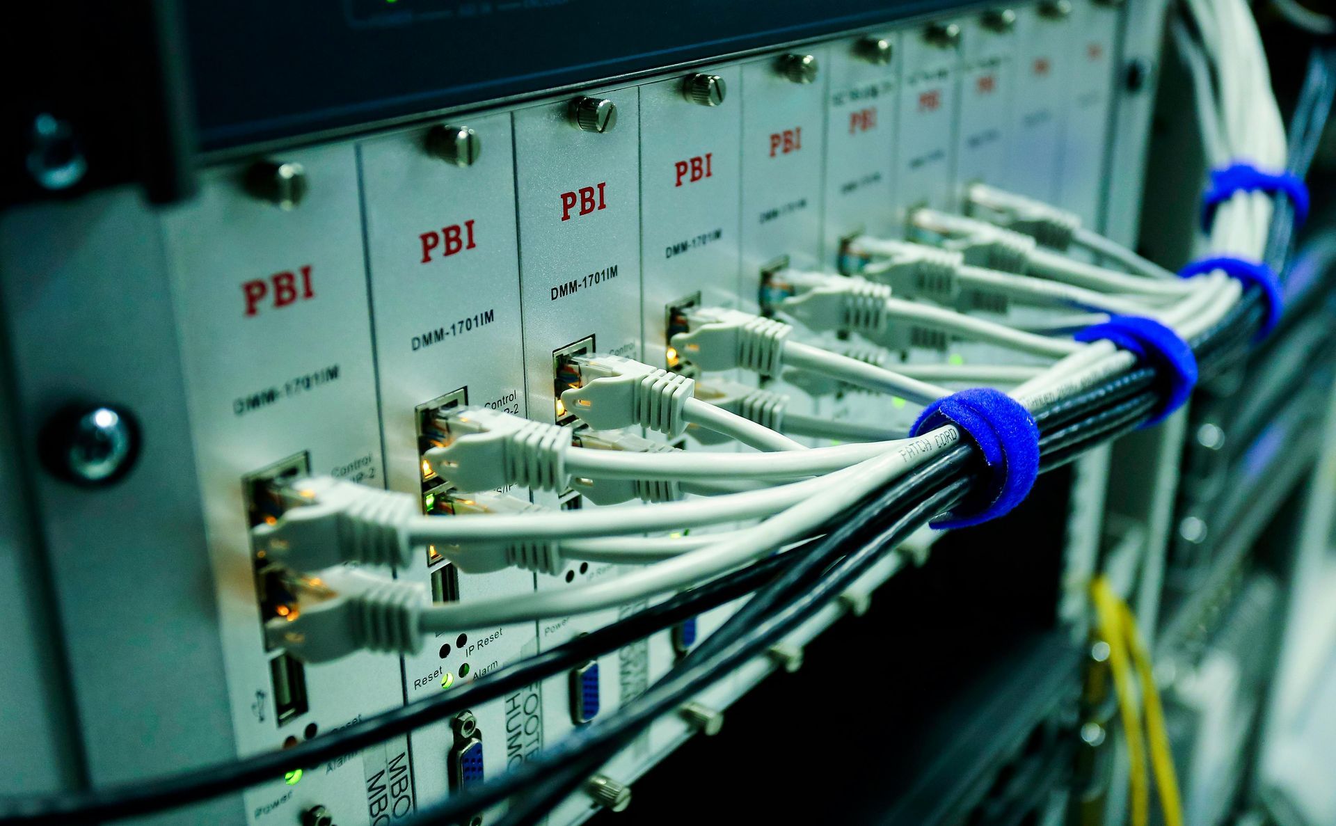 A bunch of wires are connected to a server in a data center.