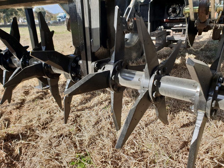 A close up of a machine with a lot of blades on it in a field.