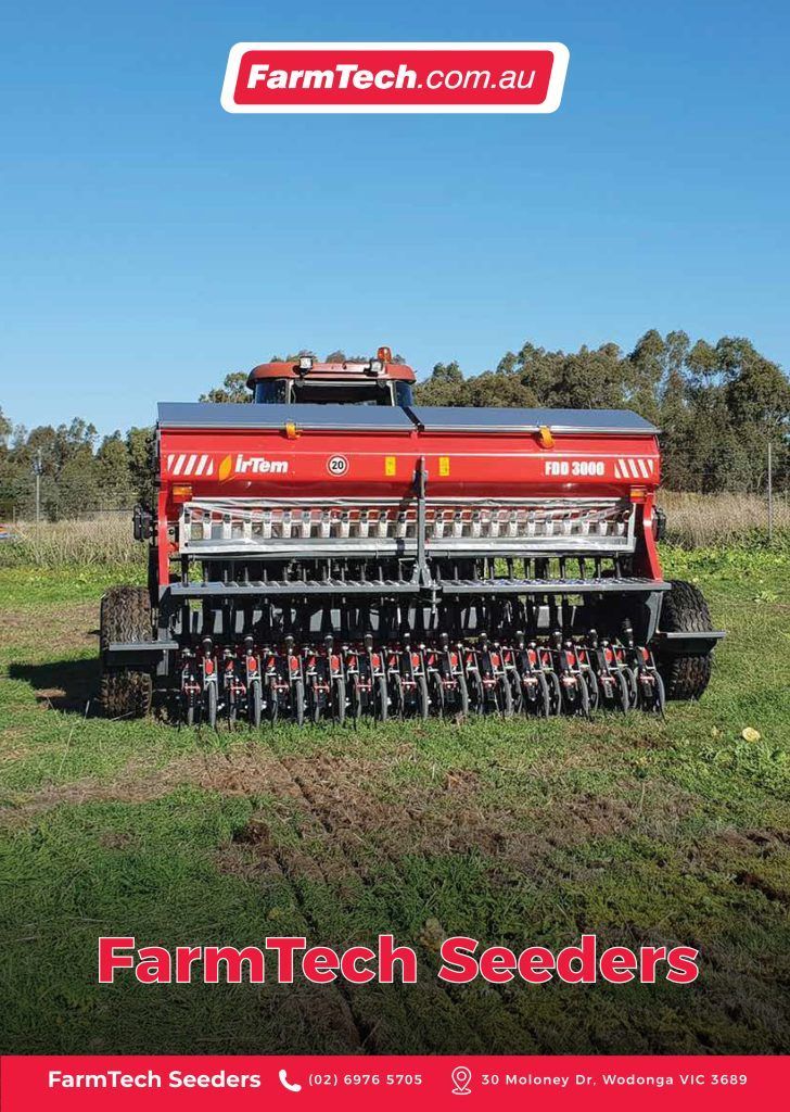 A farmtech seeder is sitting on top of a lush green field.