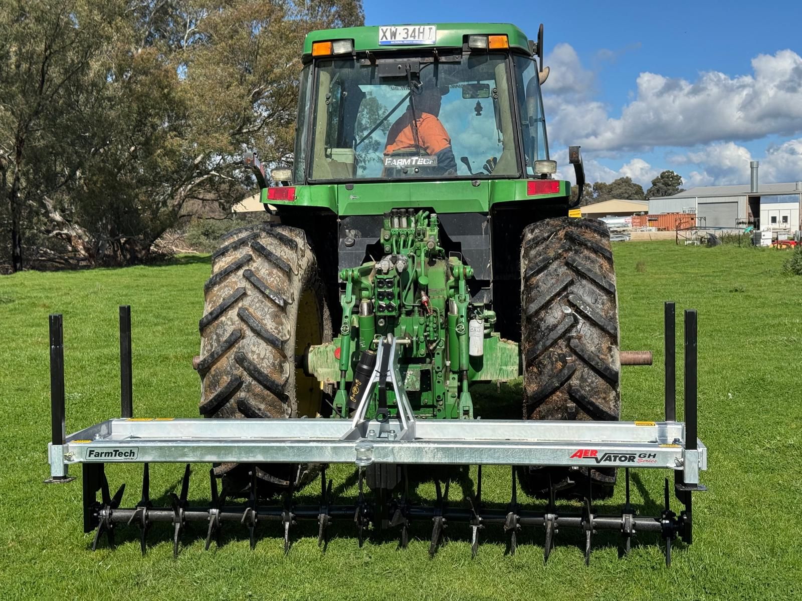 A tractor with a farmtech aerator attached to it