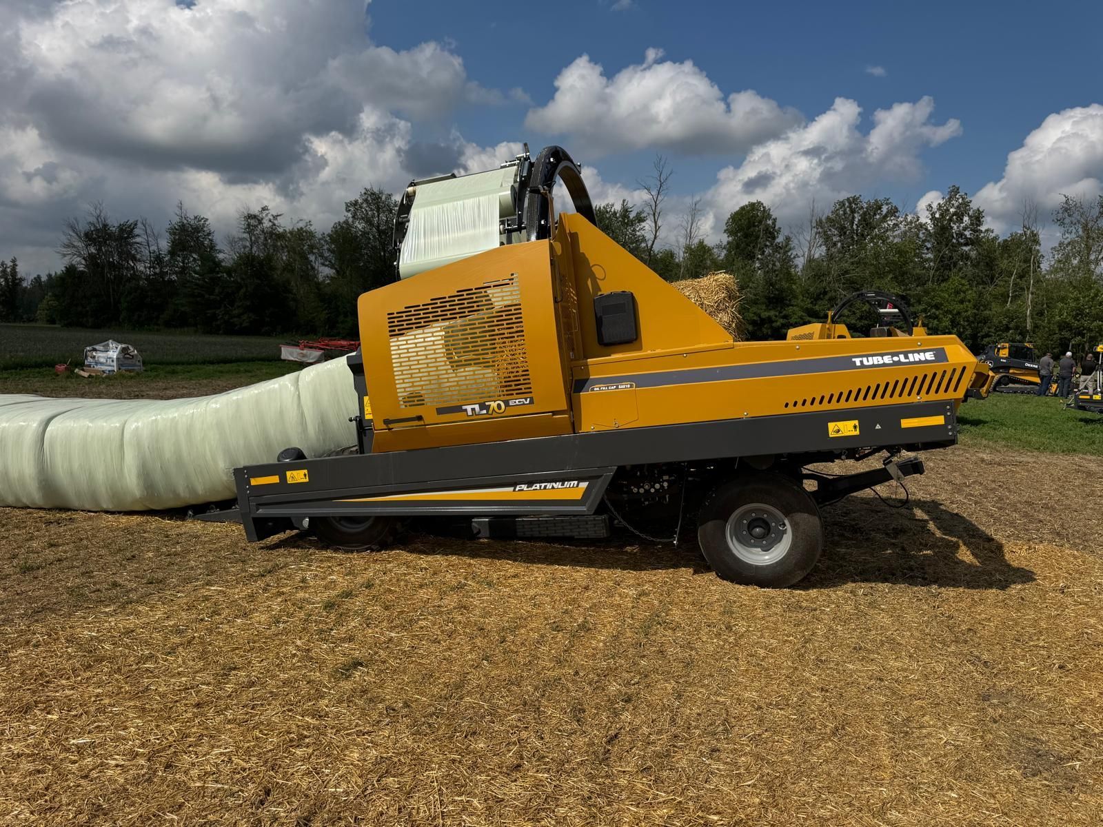A yellow and black machine on a trailer on a white background.