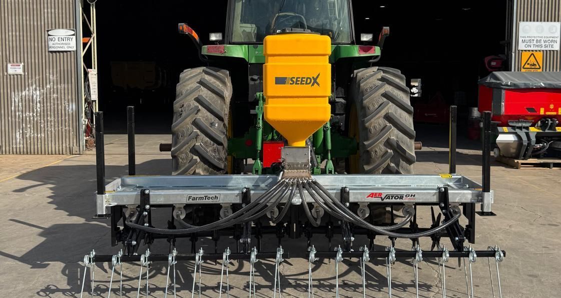 A yellow forklift is parked next to a aerator