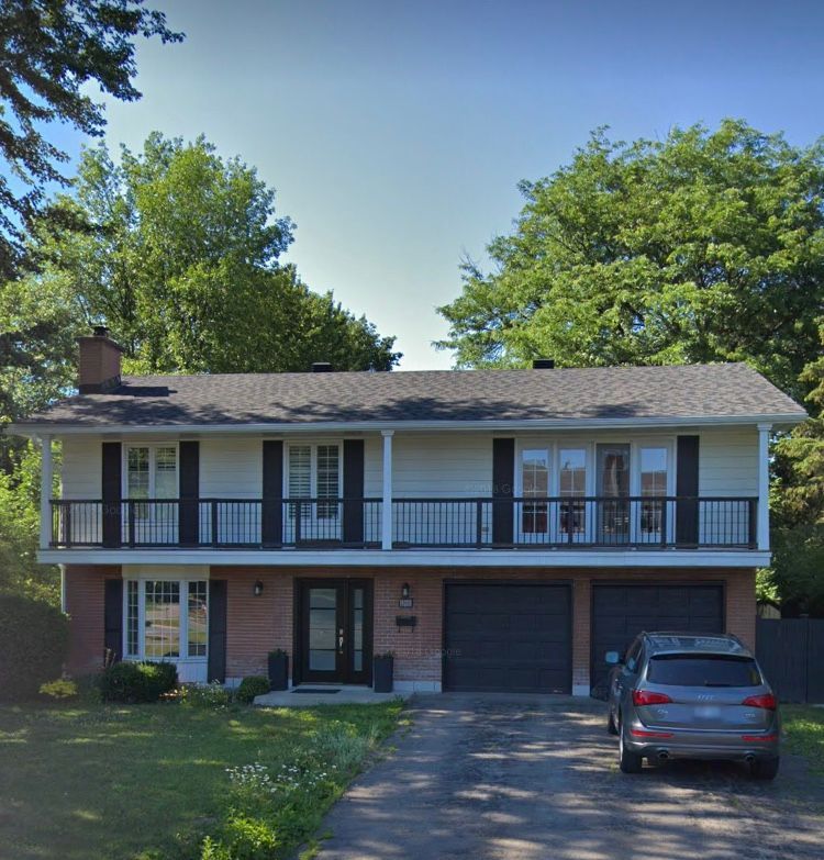 A house with a car parked in front of it
