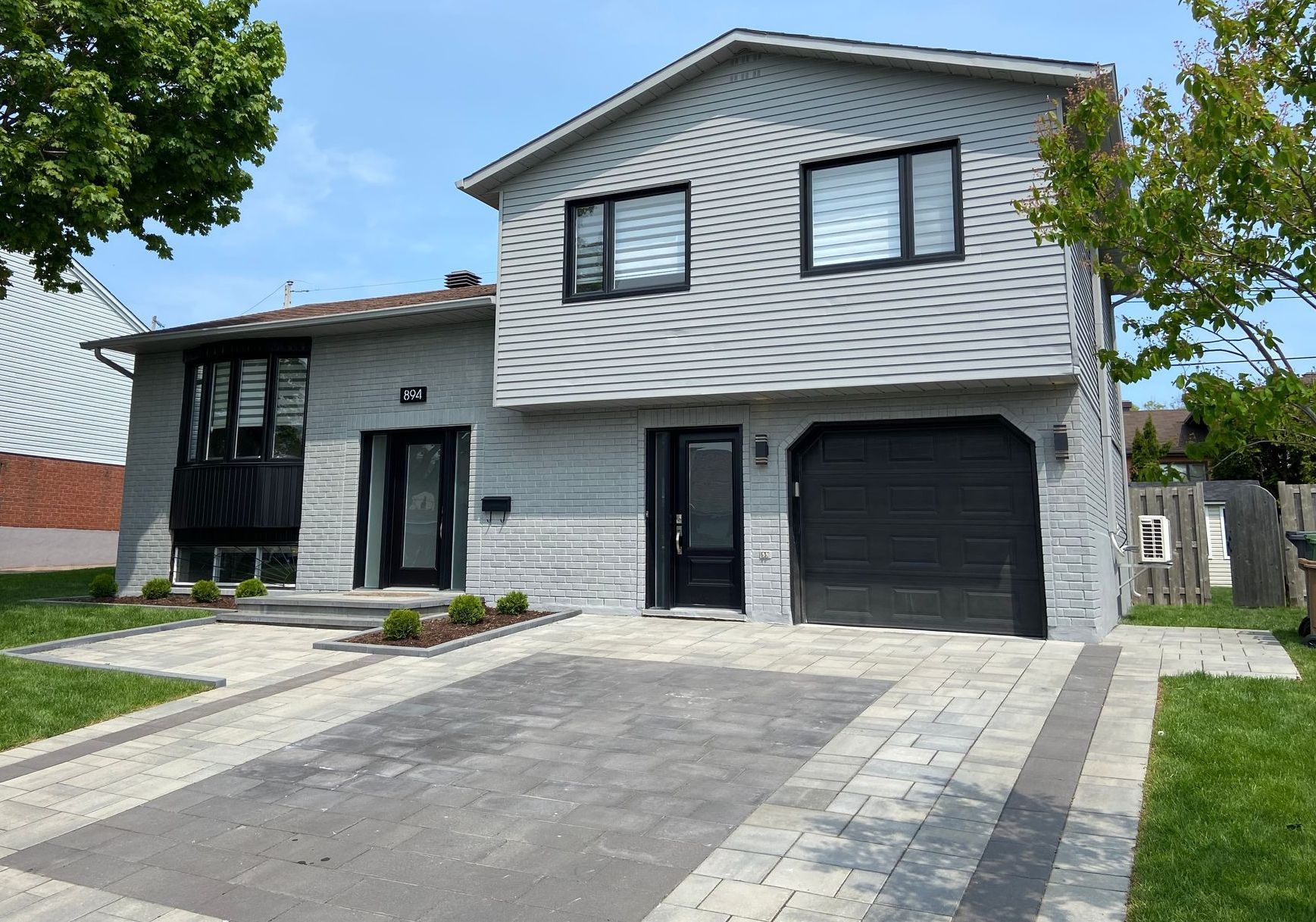 A large white house with a black garage door