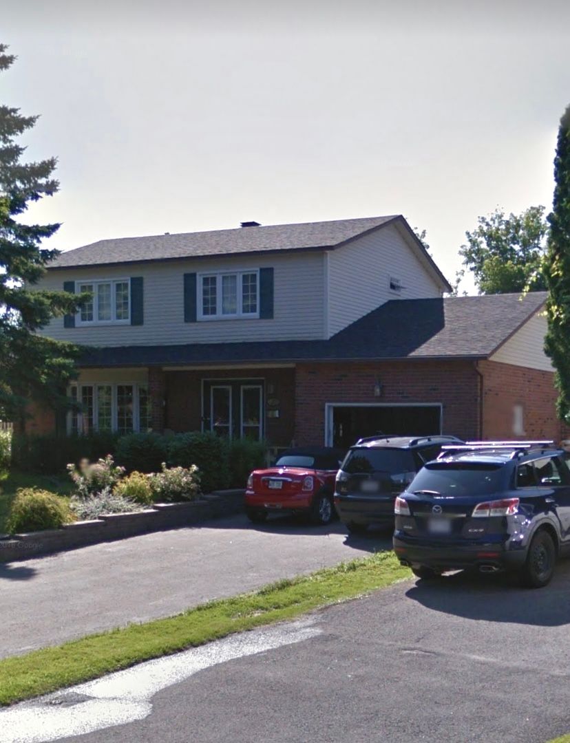 A house with a lot of cars parked in front of it