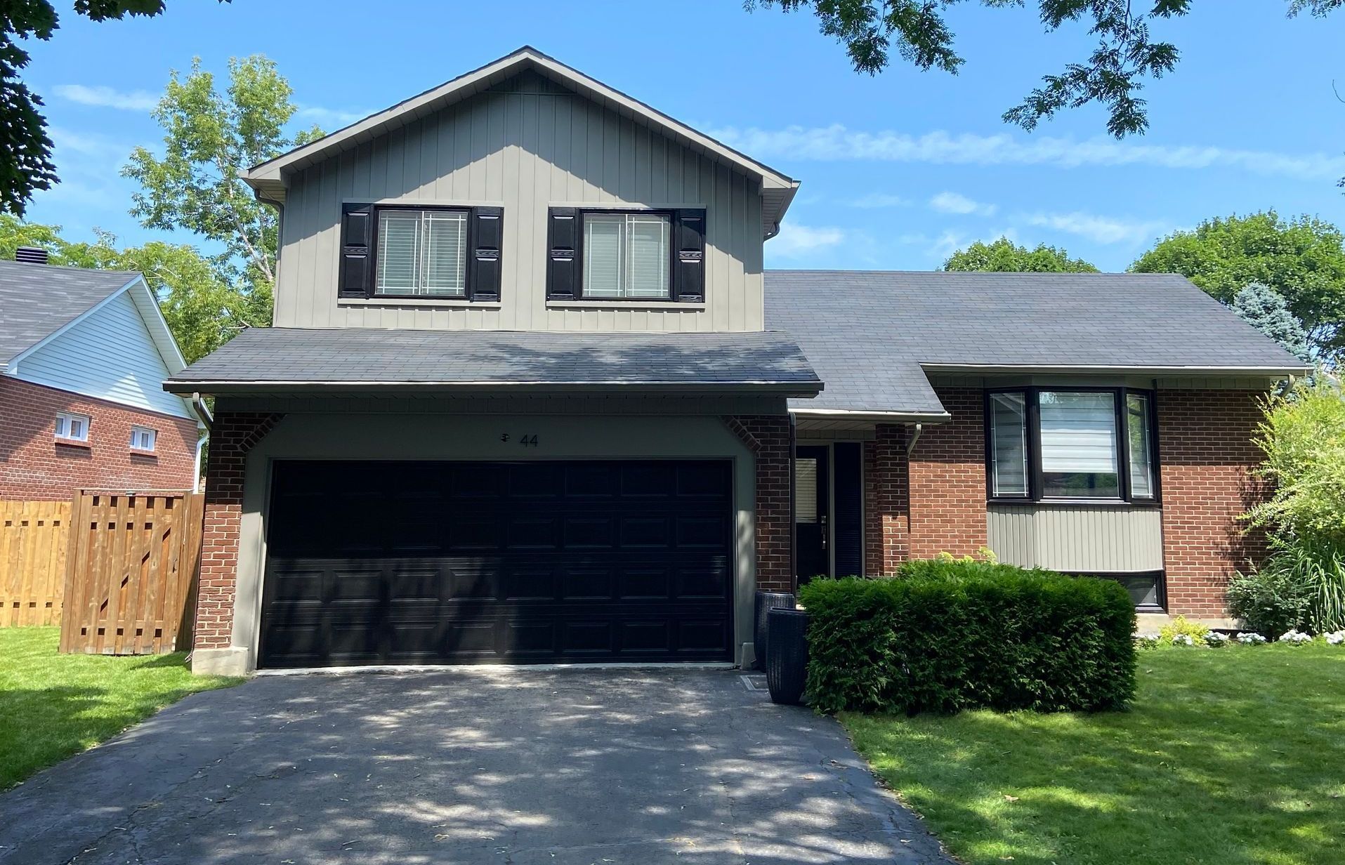 A brick house with a garage and a driveway