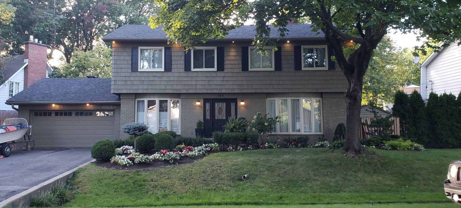 A large house with a lot of windows and a tree in front of it.