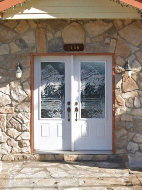 A stone building with a white door and a sign that says 1818