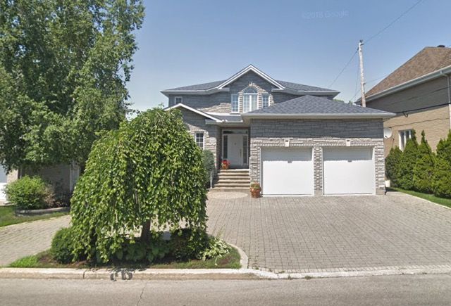A large house with two garages and a driveway