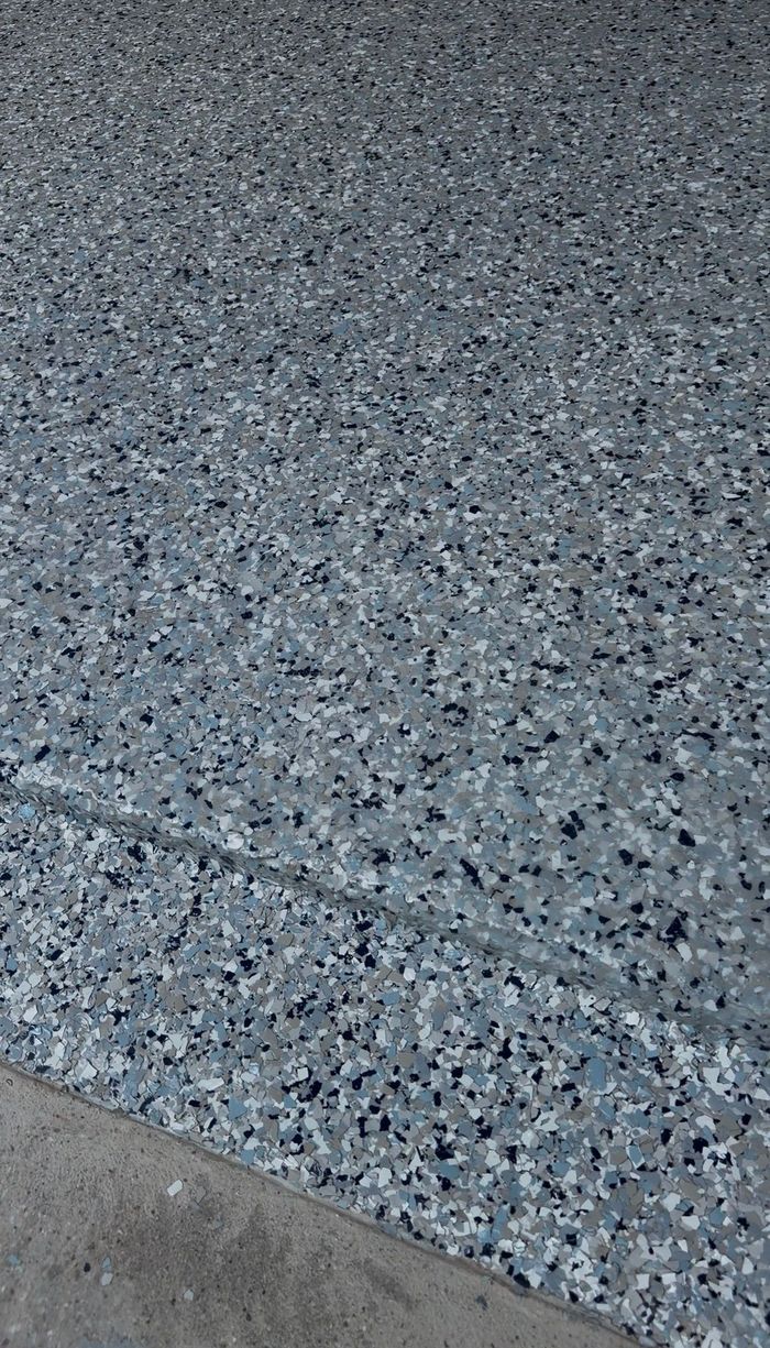 Close-up of decorative flake garage floor coating at the edge