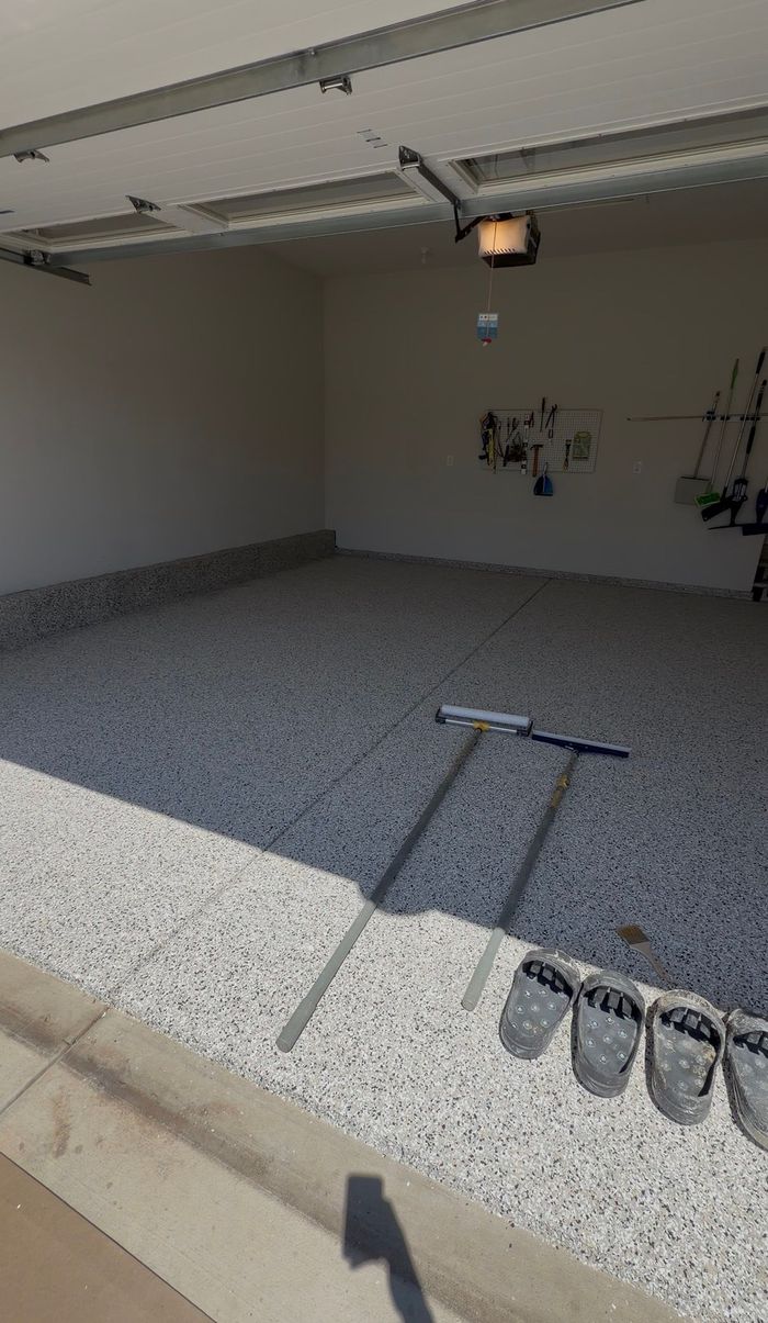 Finished two-car garage floor coating with tool storage