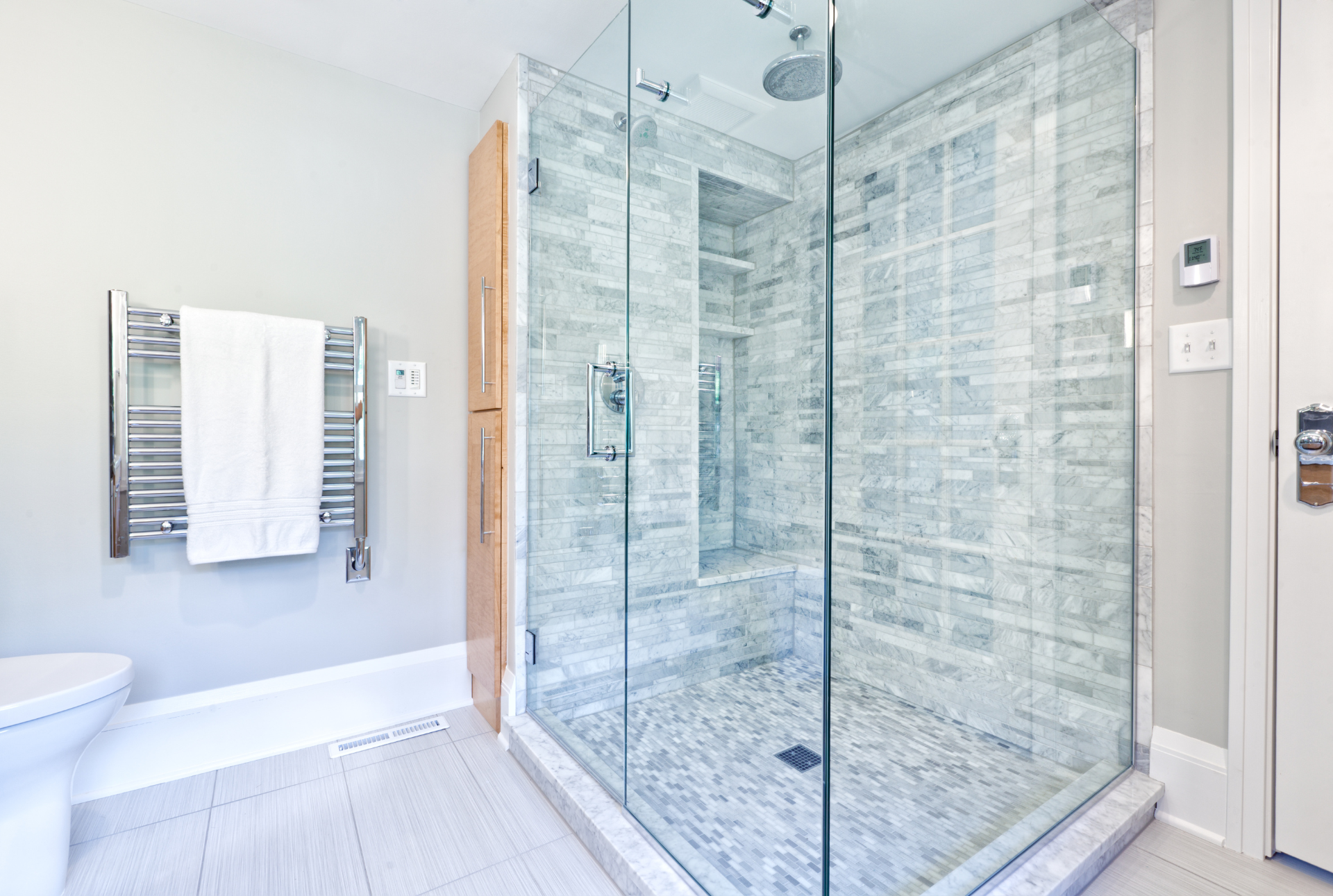 remodeled shower with a variety of grey tiles