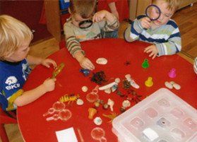 Little boys playing with magnifying glasses