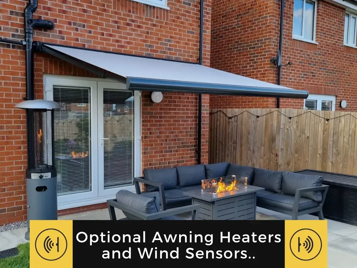 Patio with a retractable grey awning over an outdoor sofa and fire pit, with text about optional heaters and wind sensors.