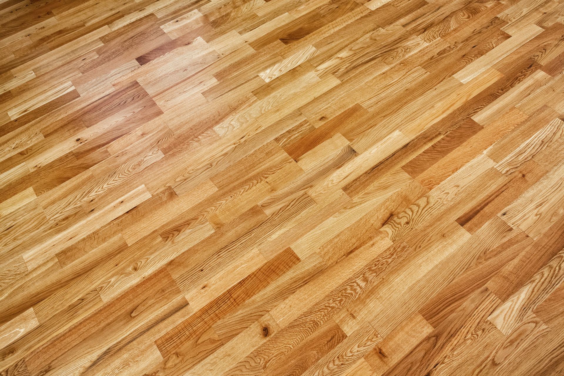 Wooden parquet flooring, light brown, diagonally arranged.