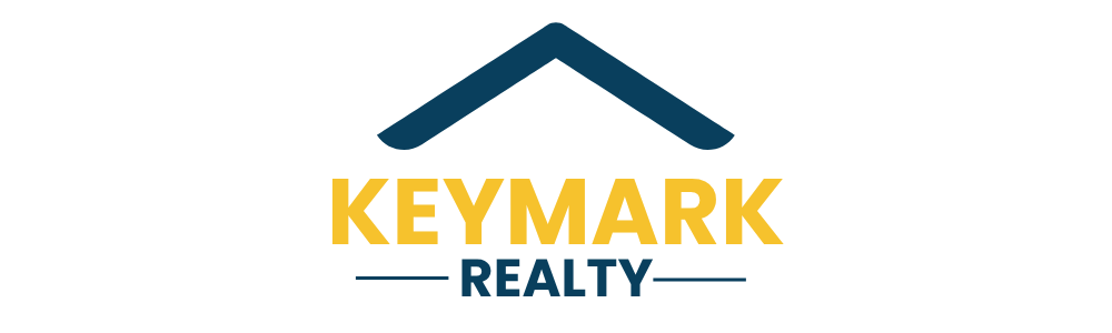 Logo for Keymark Realty: a blue house outline above gold text that reads "KEYMARK" over "REALTY."