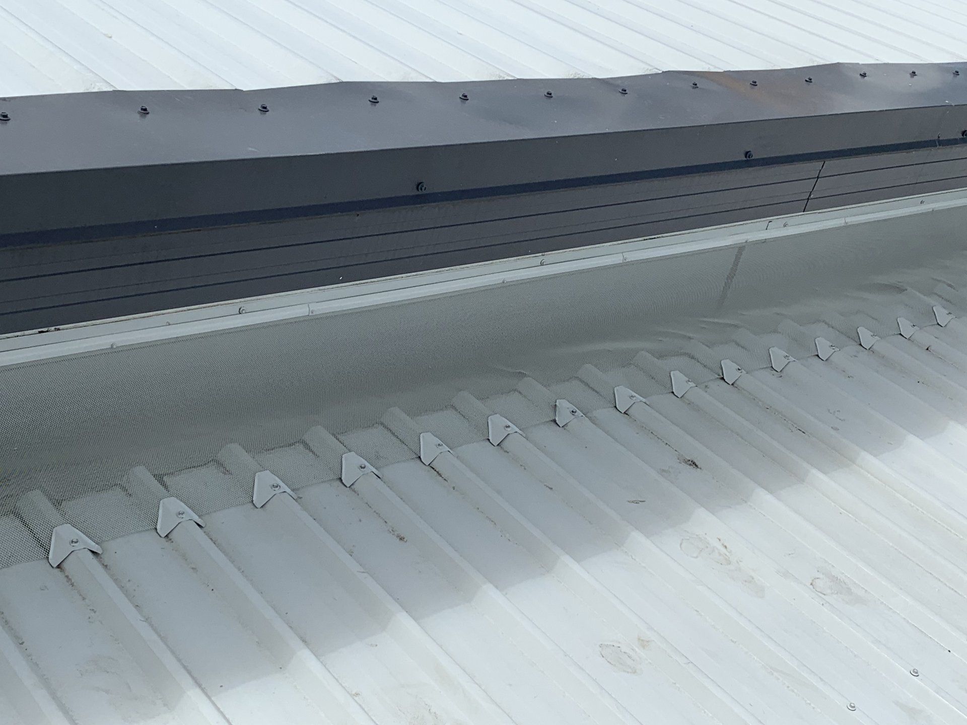 White corrugated metal roof with a shaded area near the edge.