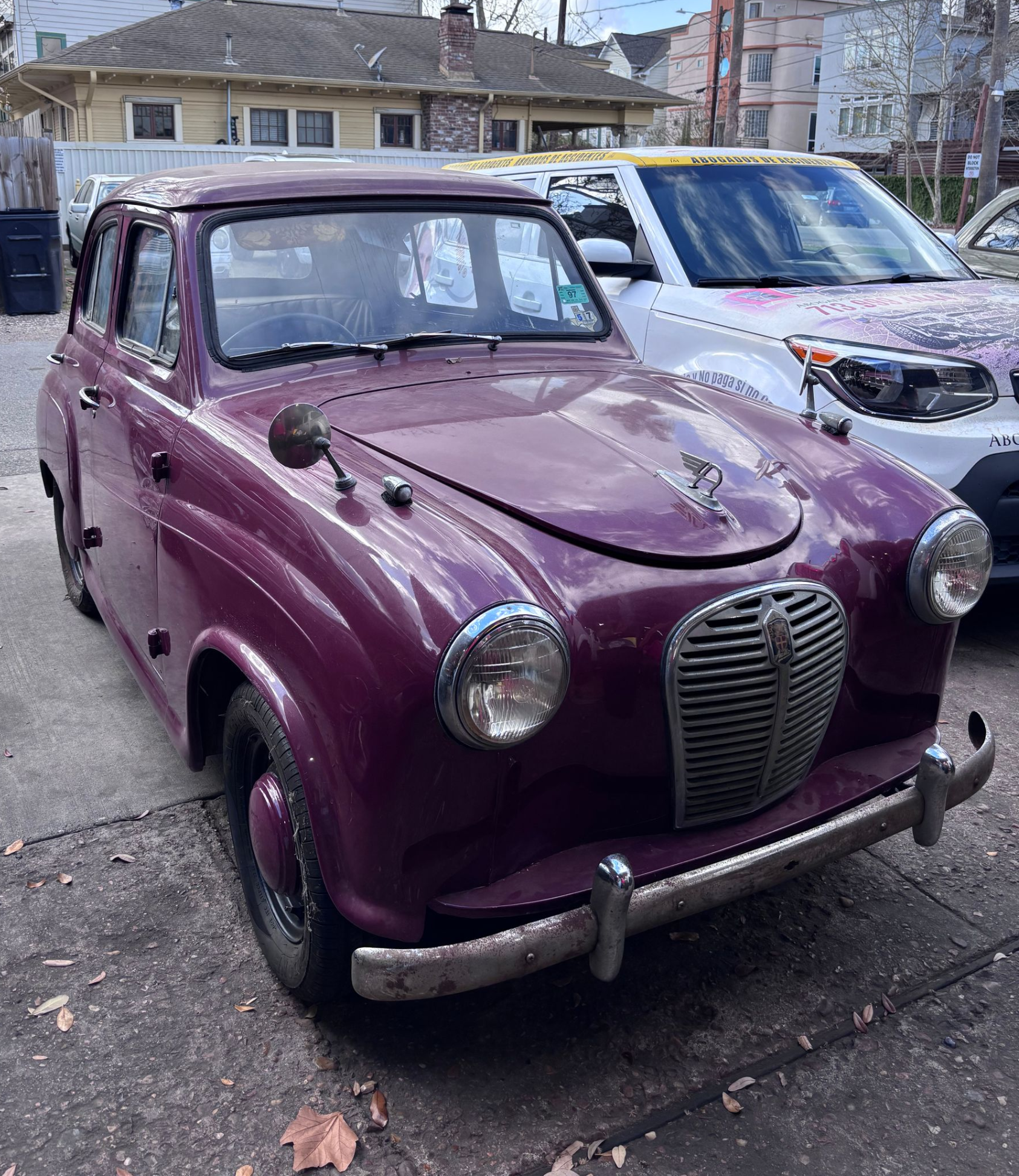 Vintage Austin A30 parked in Houston mechanic shop showing front view of classic British car