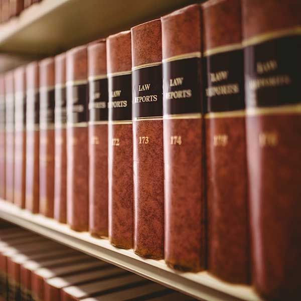 Row of red law books on a shelf with gold lettering