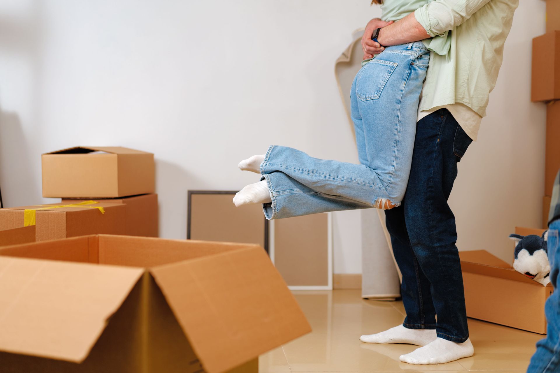 Person being lifted in a room with cardboard moving boxes