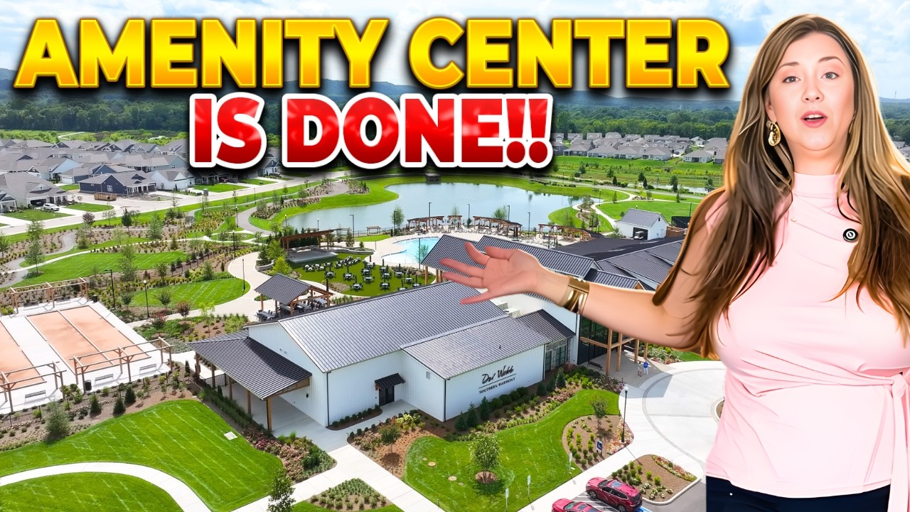 “AMENITY CENTER IS DONE!!” text over aerial view of a building and pools, with a woman pointing at it