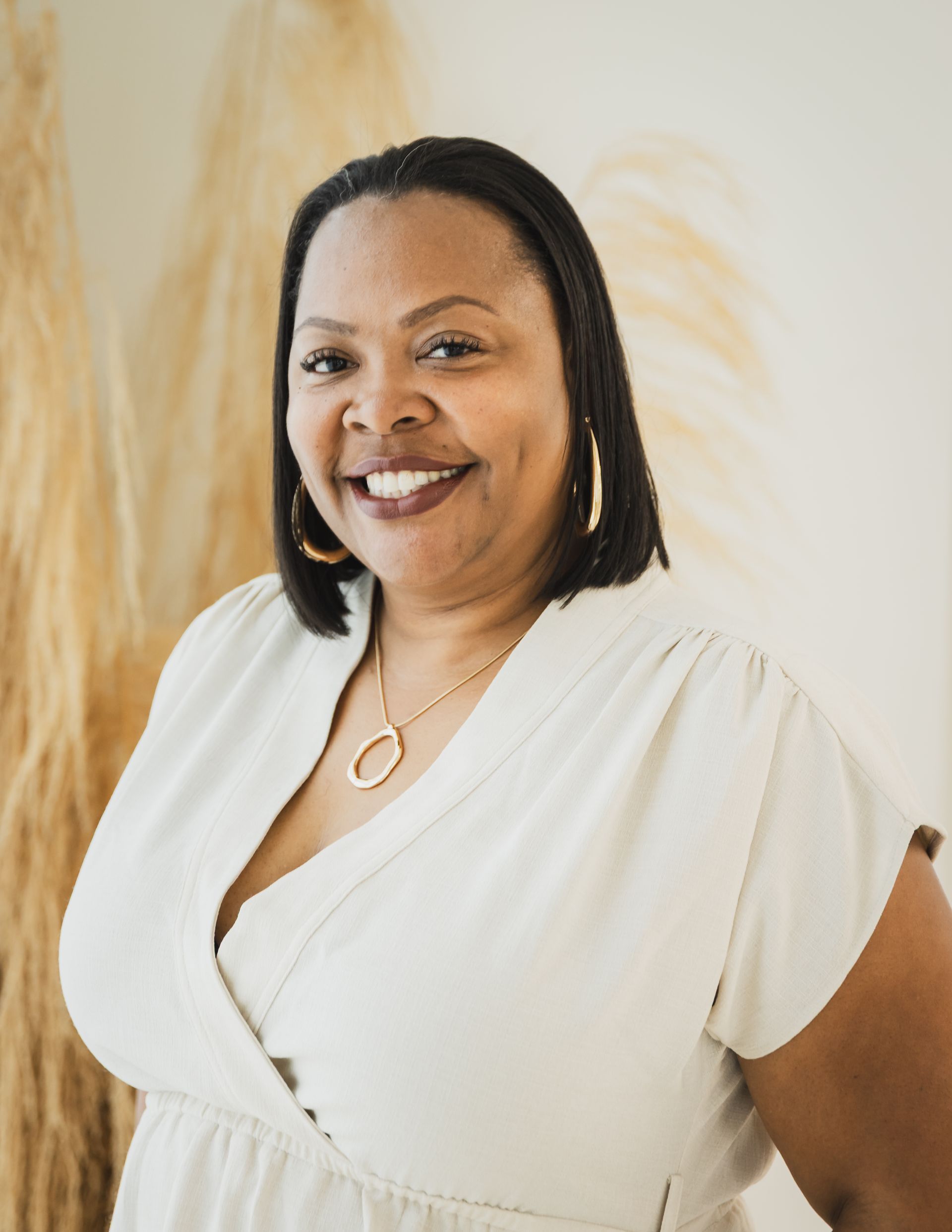 A woman is smiling and wearing red lipstick