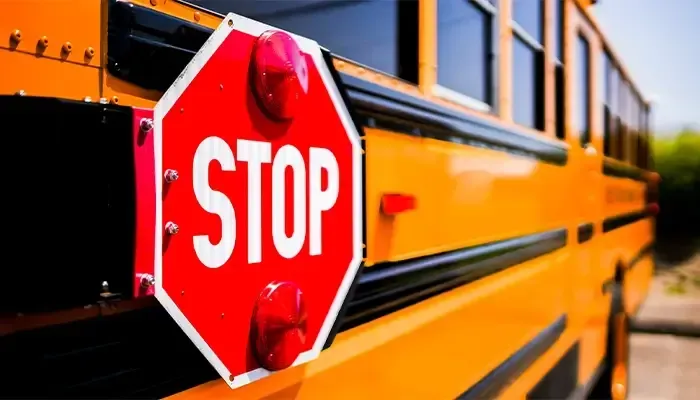 A school bus with a stop sign on the side of it.