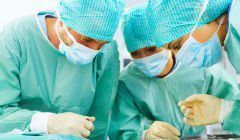 A group of surgeons are operating on a patient in a hospital.