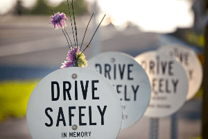 A white sign that says drive safely in memory