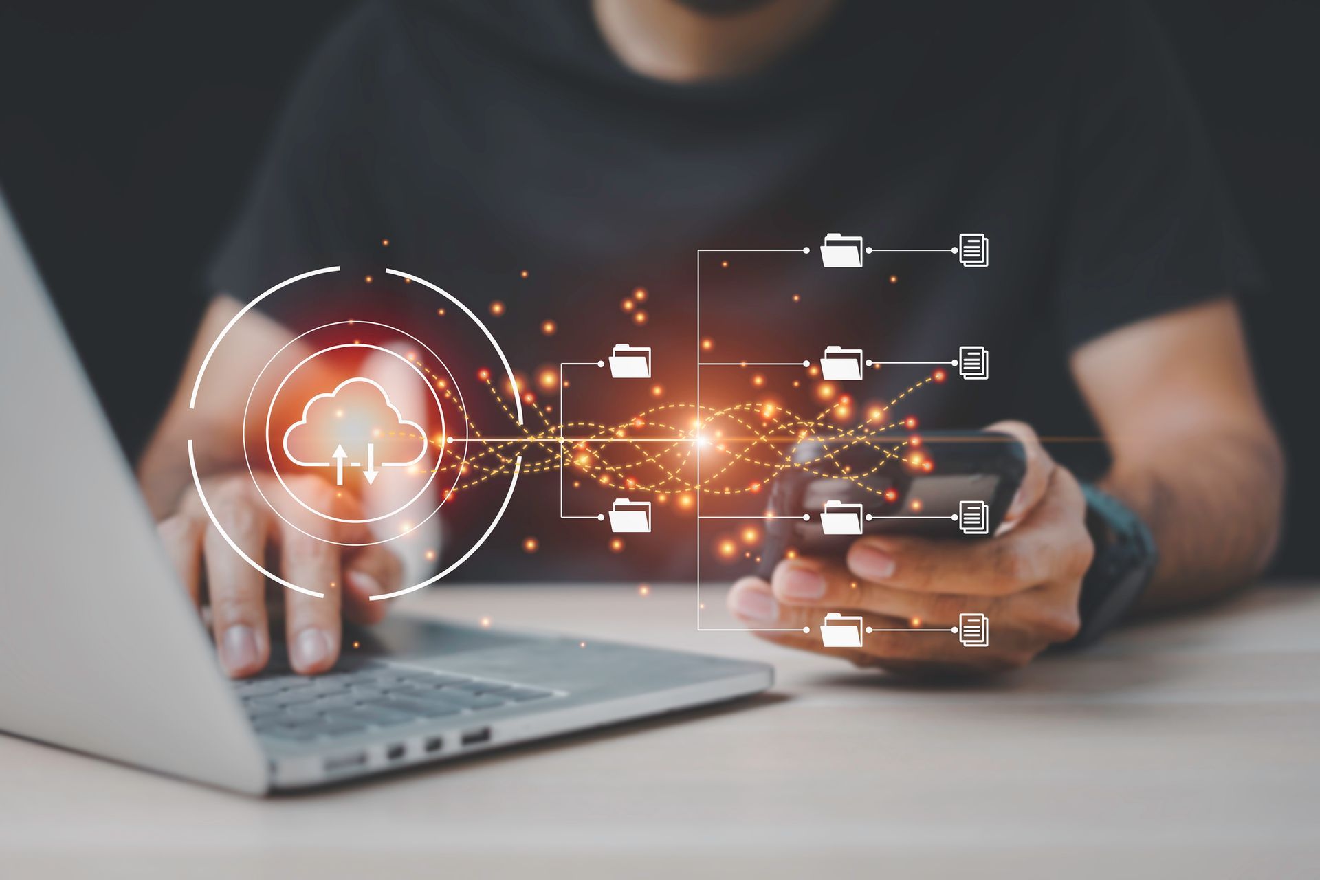 A person working on a laptop with cloud network icons and data flow graphics.