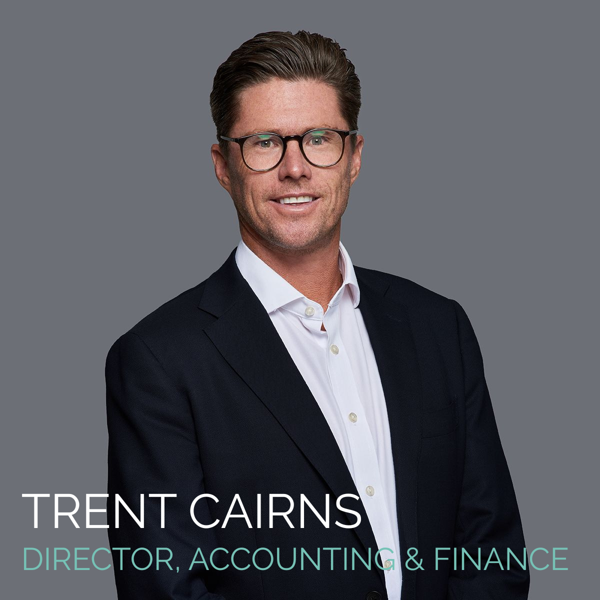 Trent Cairns, Director of Accounting & Finance, wearing a suit and glasses, smiling.