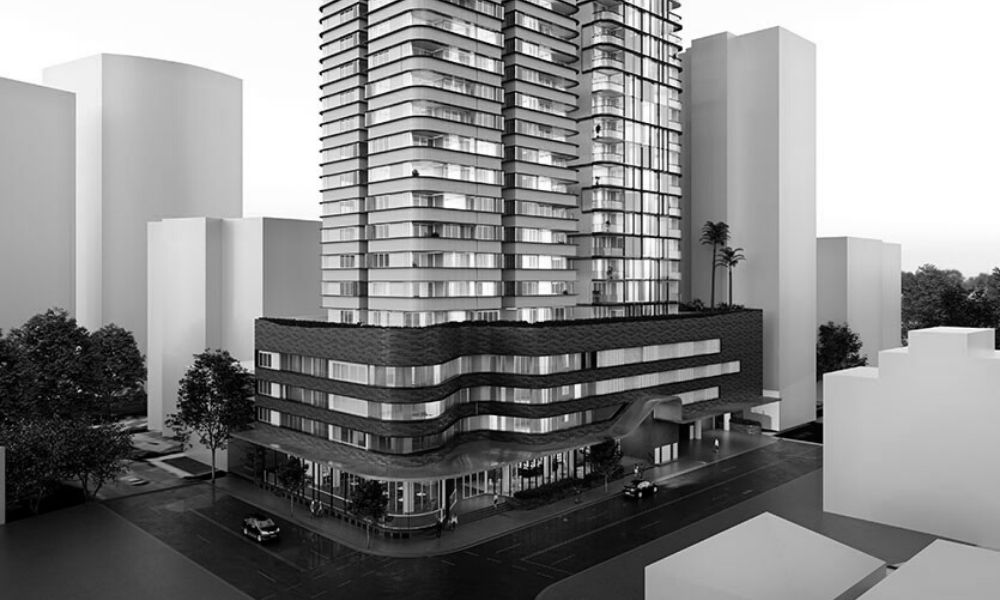 A black and white photo of a tall building in a city.