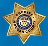 A sheriff 's badge from morgan county is on a blue background.