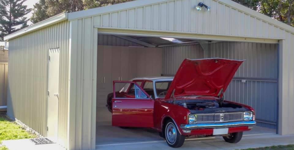 Red Car in Garage — Roofing in Goulburn, NSW