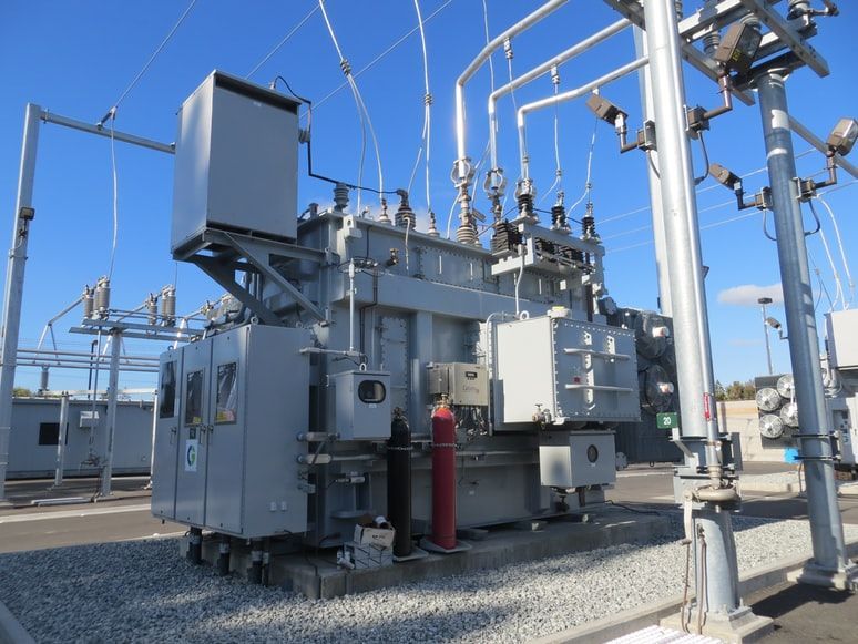 A large transformer is sitting in a power station.