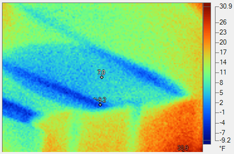 A thermal image of a building with a thermometer.