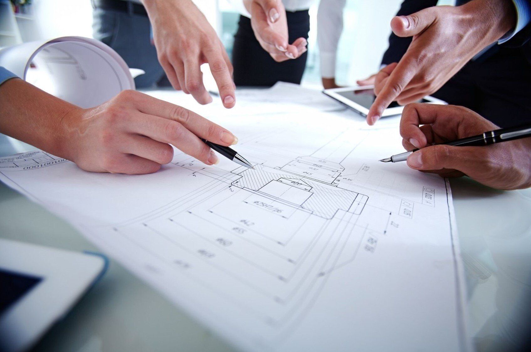 people meeting around architectural drawing