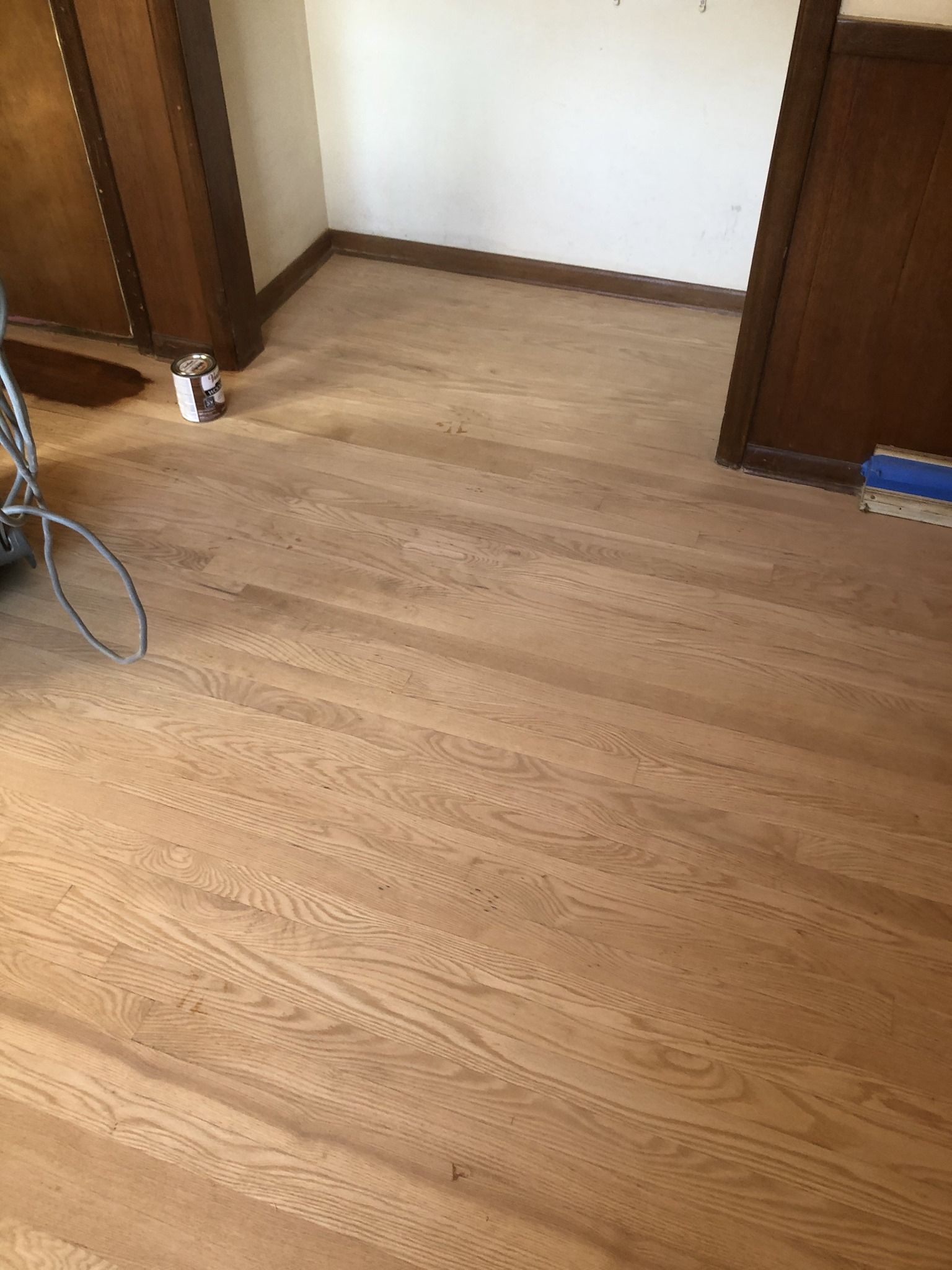 A room with a wooden floor and a chair in it.