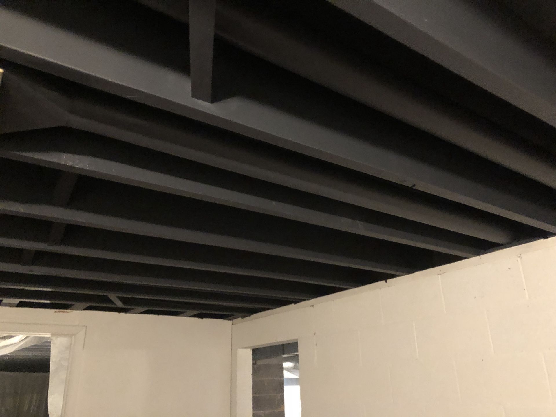 A room with a black ceiling and white walls.