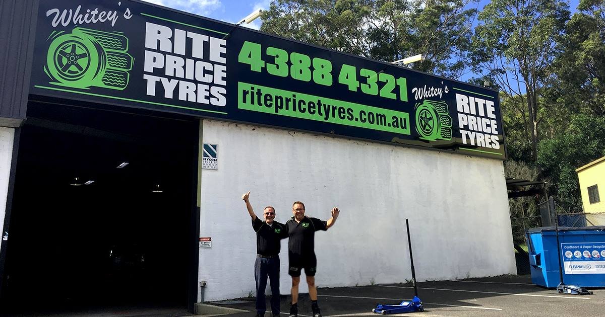 Two Men Are Standing in Front of a Building That Says Rite Price Tyres — Rite Price Tyres In Berkeley Vale, NSW