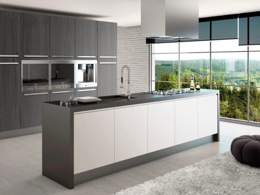 A luxurious modern kitchen with modern European, frameless cabinets and large windows
