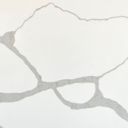 A close up of a white marble counter top with a gray texture.