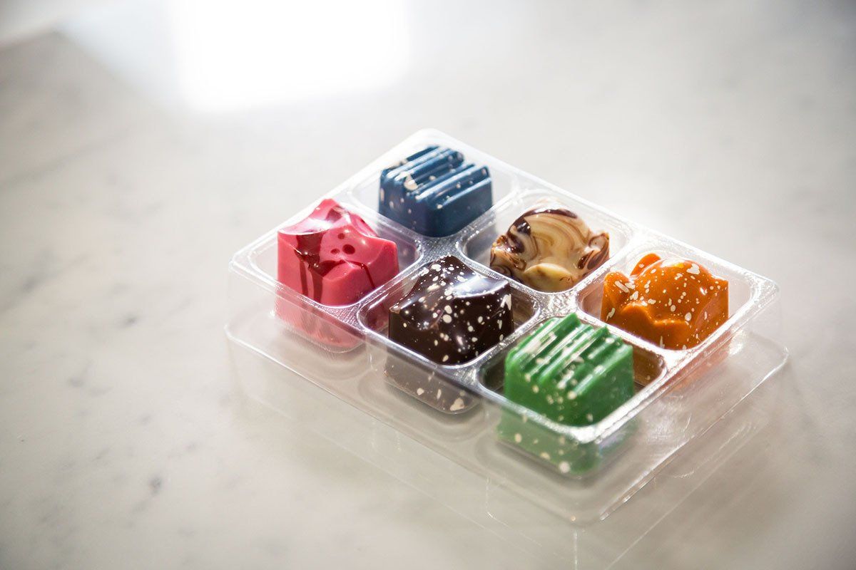 Multiple chocolate shape in different color display with a transparent box