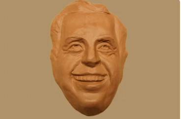 A chef mholding 4 custom made chocolate