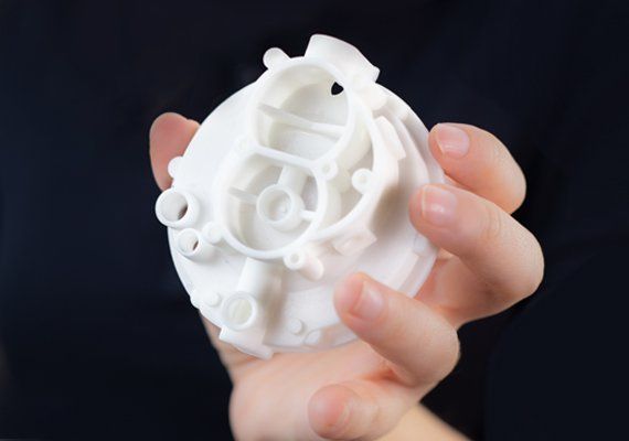 white industrial prototype holding by a engineer