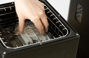 Engineer goint to take a 3d printed part from ultrasonic tank